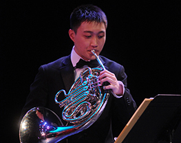 Student playing the french horn